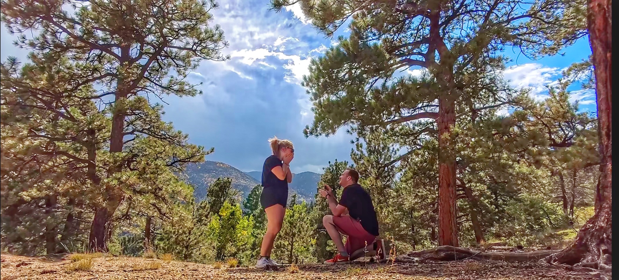 Andrew proposing to Shelby on a mountain top